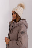 Cozy winter beanie with turn-up, plaid weave, and pom-pom.