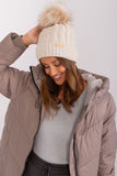 Cozy winter beanie with turn-up, plaid weave, and pom-pom.