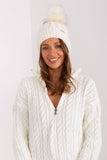 Cozy winter beanie with turn-up, plaid weave, and pom-pom.