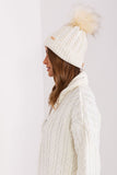 Cozy winter beanie with turn-up, plaid weave, and pom-pom.