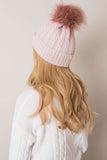 Stylish winter beanie with turn-up, plaid weave, and pom-pom.